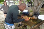 Owner Shane Young prepares conch for a beach-side barbecue. Shane owns Pirates Point Adventure Tours.